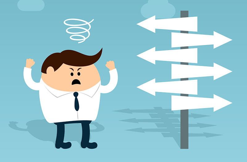 Grafica: omino arrabbiato accanto a un cartello con molte frecce